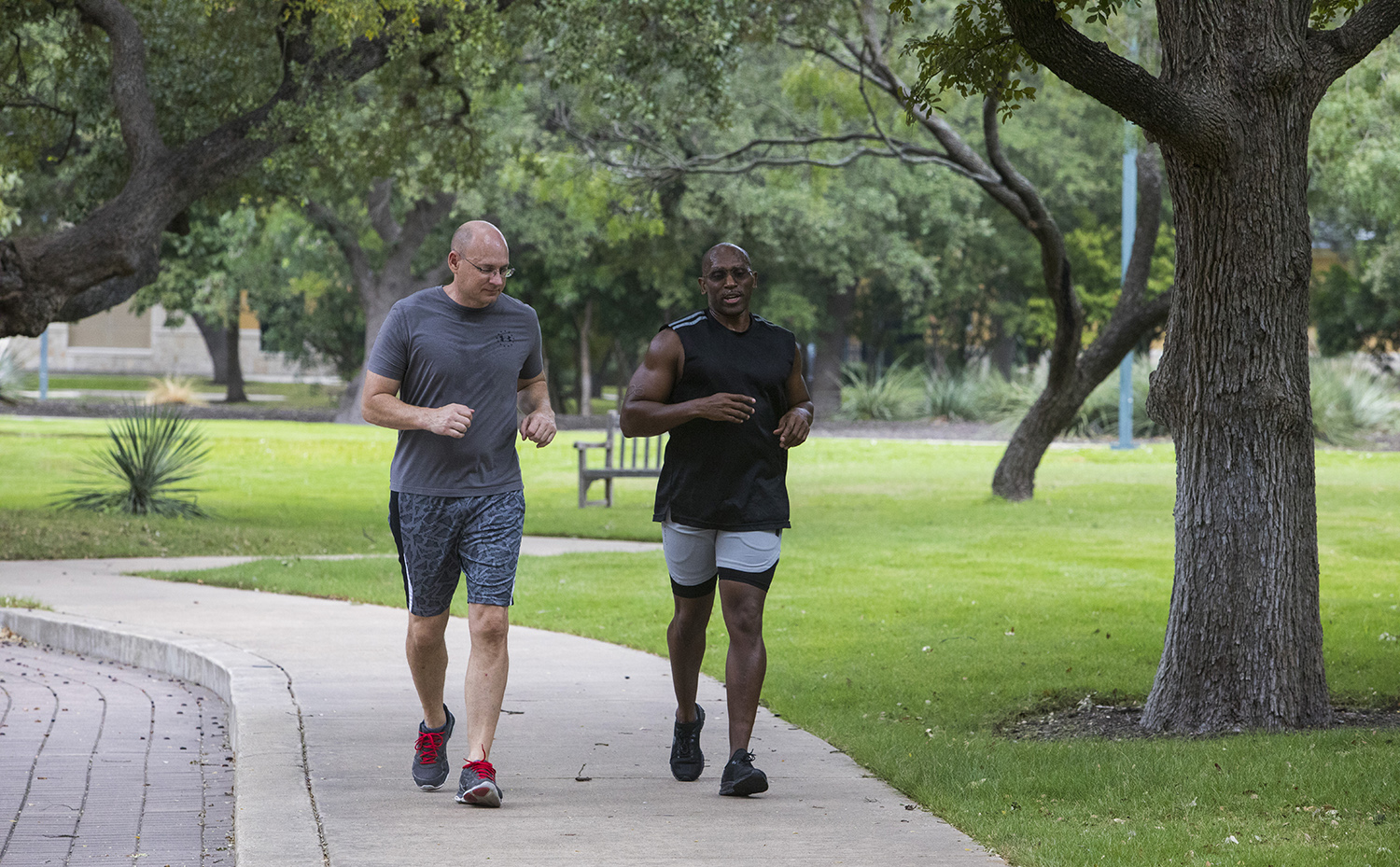 Two Valero employees jogging on a path