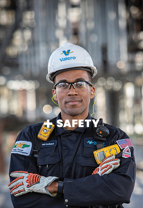 A Valero employee stands in a refinery. Text reads: Safety.