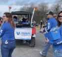 Valero volunteers during a parade, handing out goodies