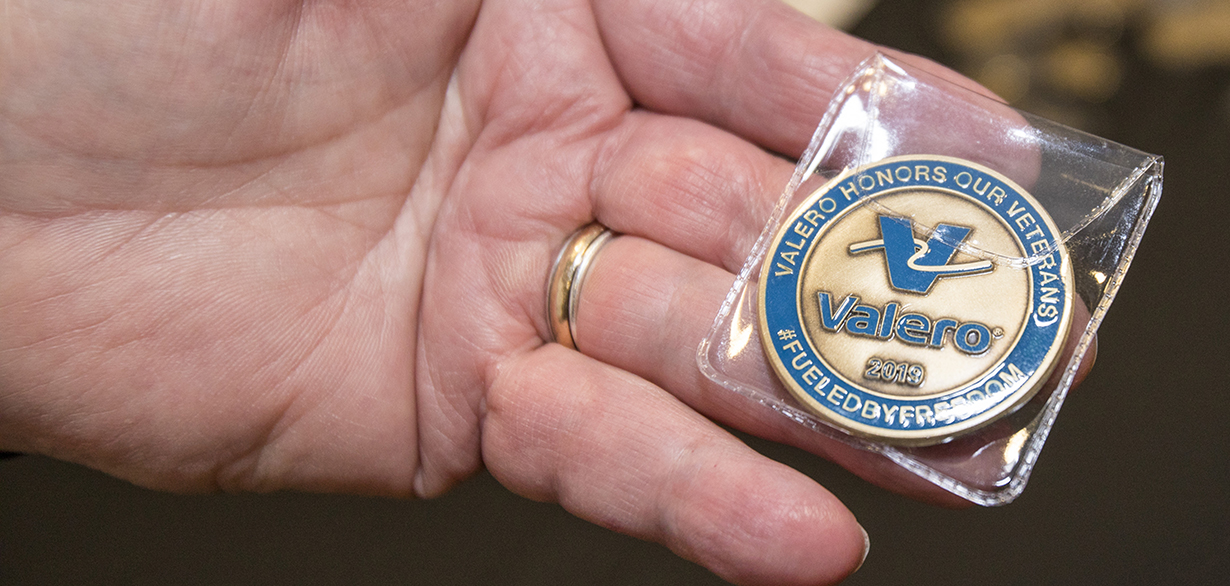 Hand holding Valero Veterans Coin