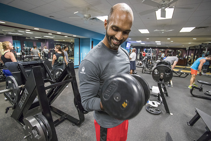 Employee lifting weights in gym