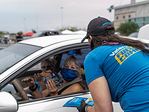 Valero volunteer distributes pre-paid gas card to community members