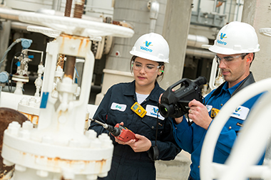 Valero employees using leak detection and repair equipment