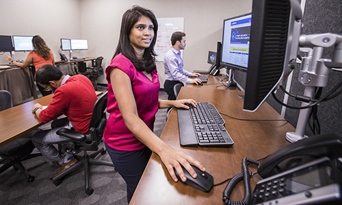 IT employee working in a team of professionals on computers