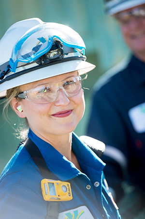 Smiling refinery operator with goggles and PPE
