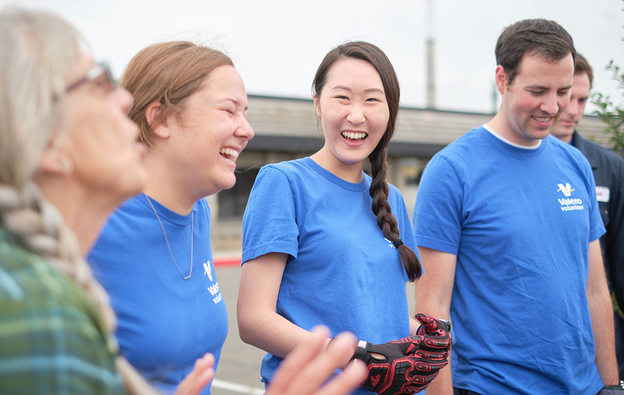 Employees laughing together at a volunteer event