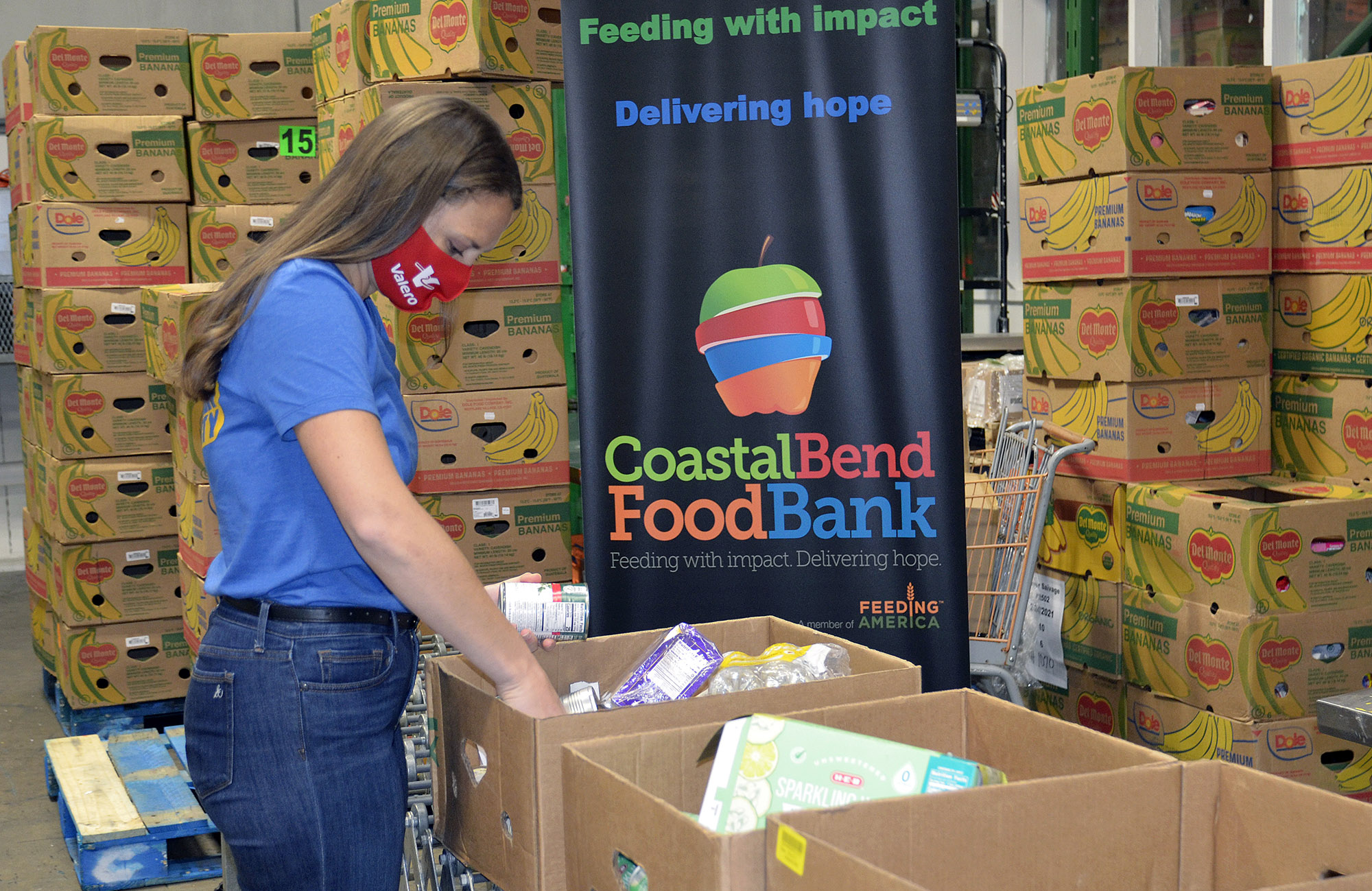 Volunteer packing food boxes