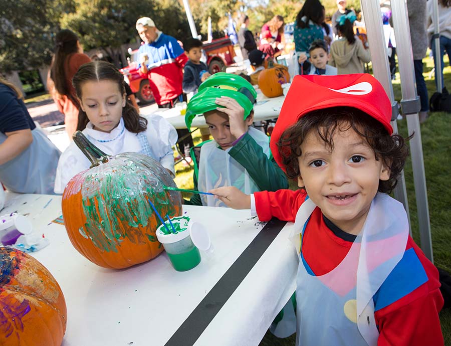 A child paints a pumpkin during Valero's annual Fall Fest.