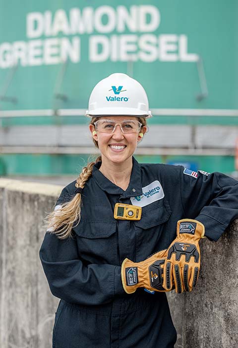 A Valero employee stands in front of Diamond Green Diesel branding.