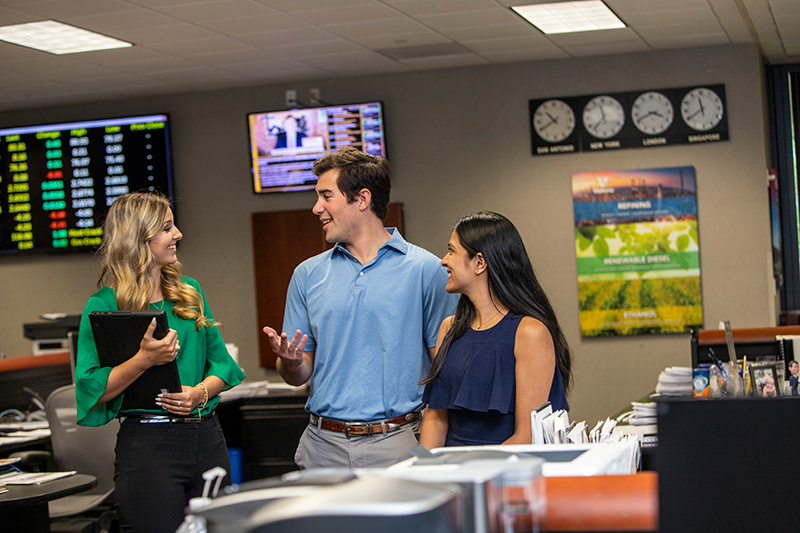 Three employees chatting.