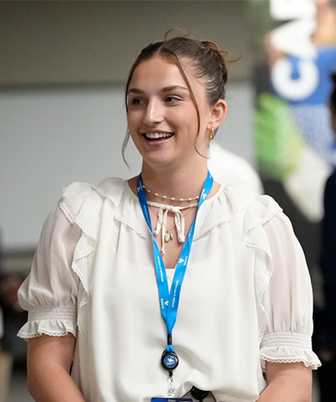 Intern smiling in business/professional attire.