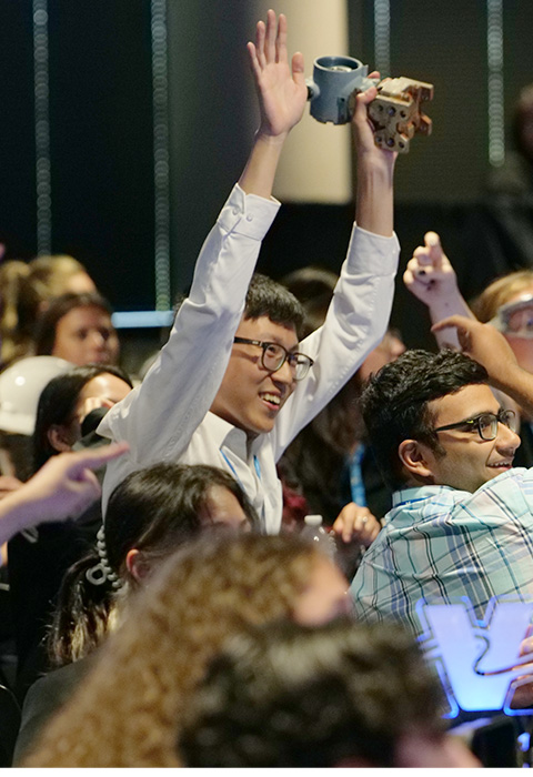 Intern cheering with hands in the air.