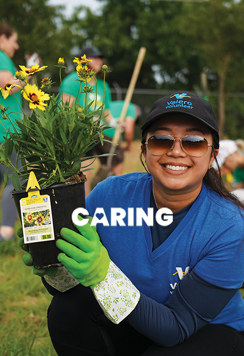 A Valero volunteer plants a flower. Text reads: Caring.