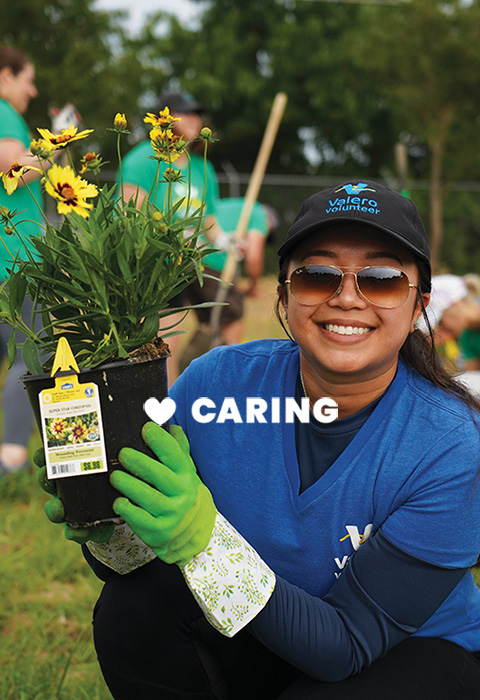 A Valero volunteer plants a flower. Text reads: Caring.