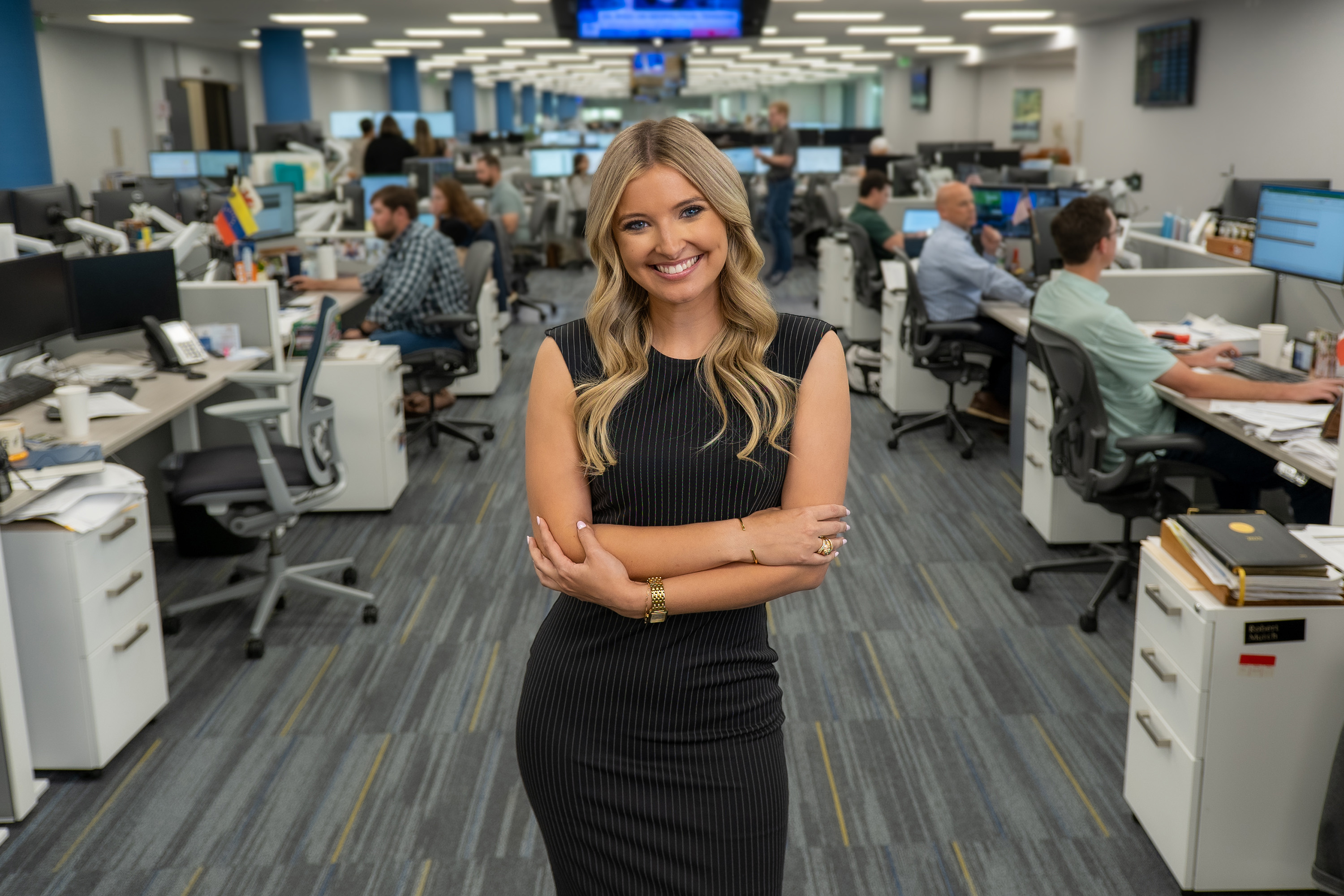 Former intern standing in the middle of commercial floor operations.