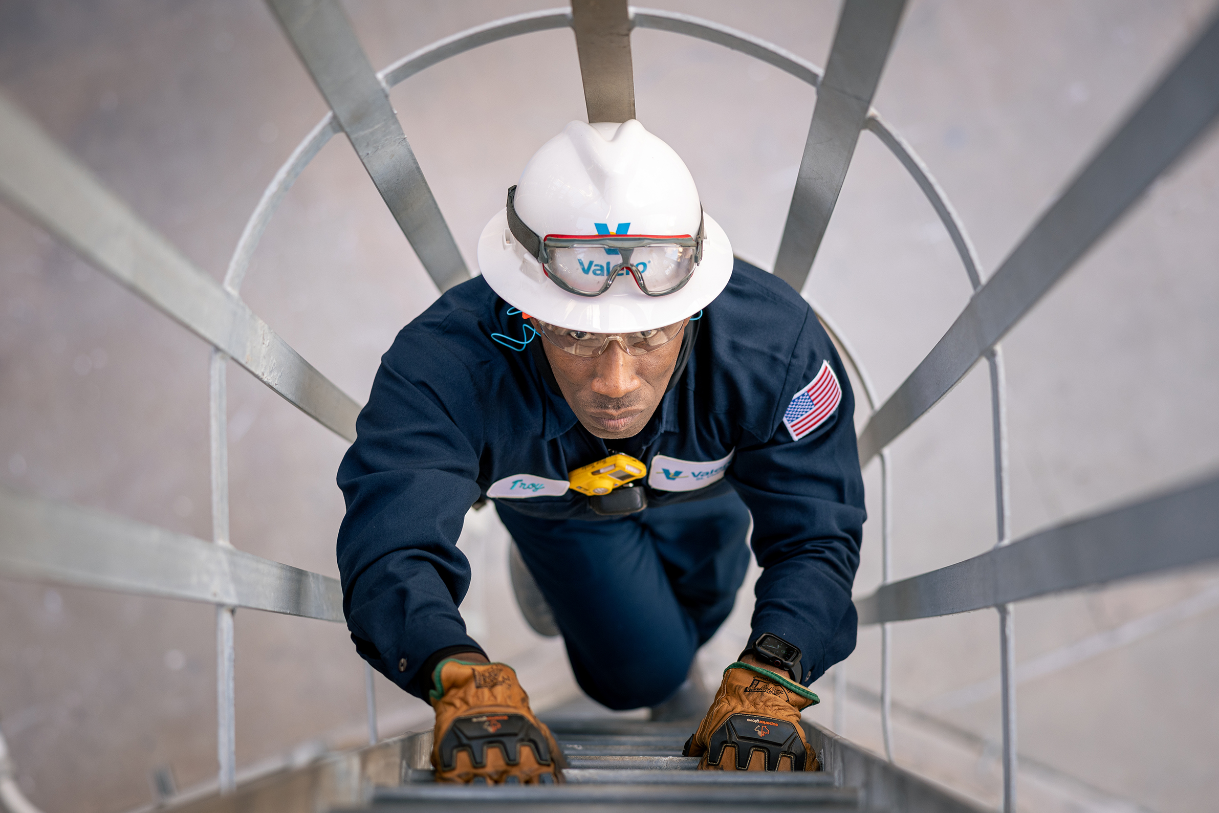 Valero St. Charles Employee climbing ladder inside the refinery