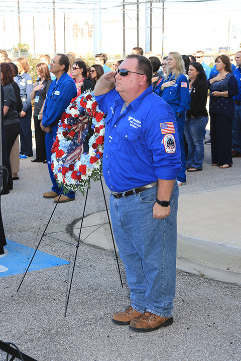 Valero employee and veteran salutes flag