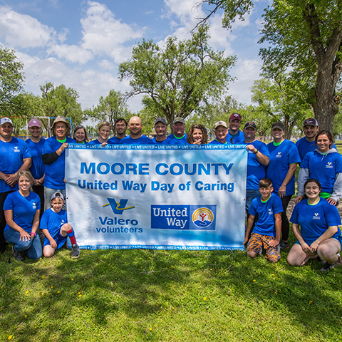 Valero Volunteers holding Moore County United Way Day of Caring sign