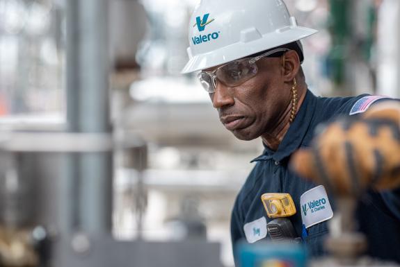 Valero employee turns a knob at the St. Charles Refinery