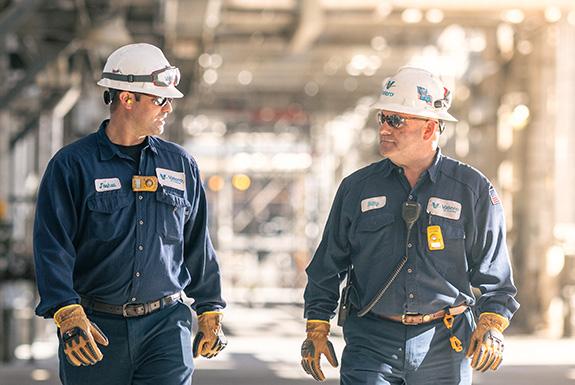 Two coworkers walk together at Valero's St. Charles refinery.