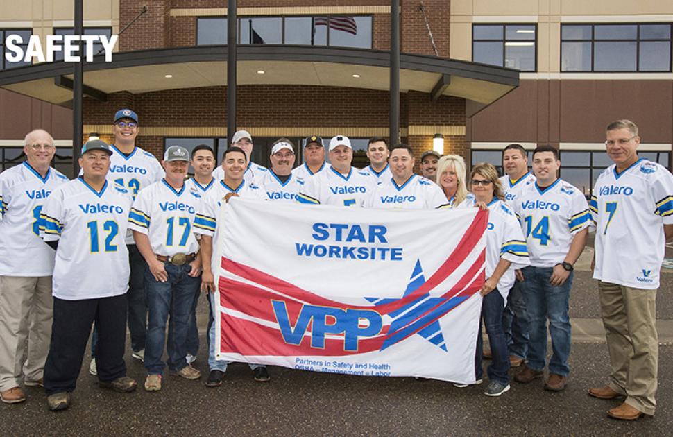 Refinery Safety Team members gather with a VPP Star Site flag