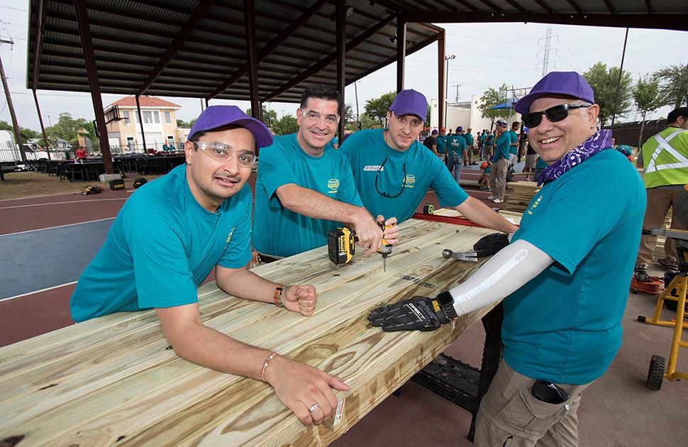 Valero volunteers build picnic tables