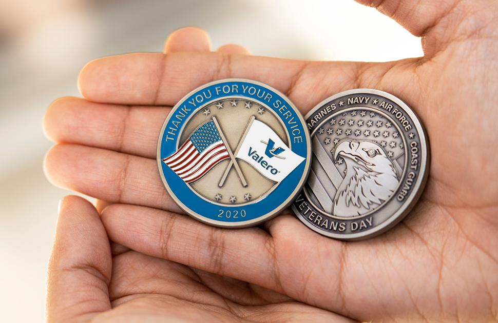 Photo of hands holding the two Valero Veteran coins