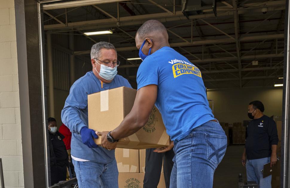 Volunteers moving food boxes