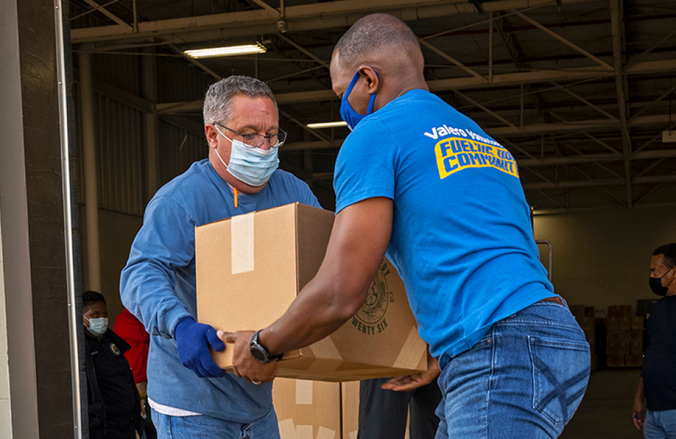 Volunteers help load supplies at a local food bank.