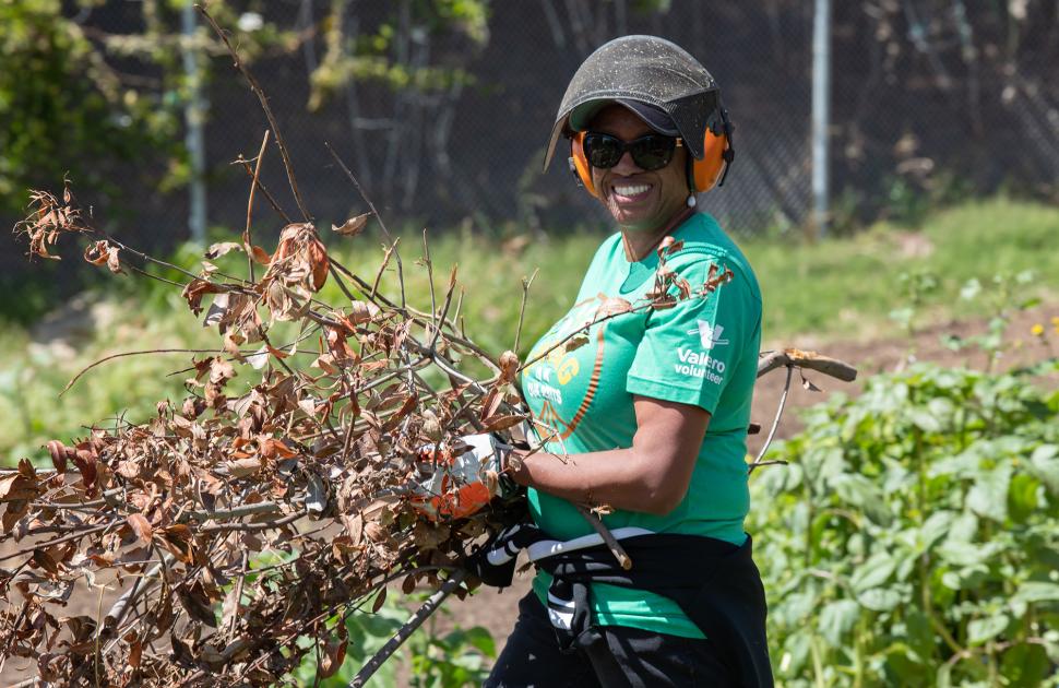 Woman clears brush as part of Earth Day project