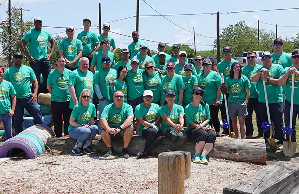 Refinery volunteers gathered at a playground during an outreach event