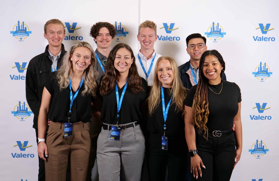 Intern group posed at a Valero branded photobooth.