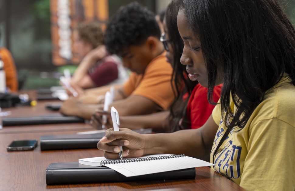 Summit student in session writing notes
