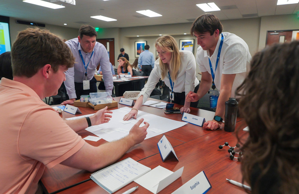 Interns collaborating at Symposium
