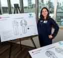 Expectant mom and engineer models a prototype for a maternity-style nomex suit