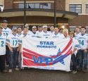 Refinery Safety Team members gather with a VPP Star Site flag