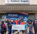 Photo of Valero employees outside of "Soldiers' Angels" with a donation