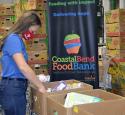 Volunteer packing food boxes