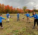 Valero Volunteers hold shovels in a field at a volunteer event