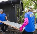 Volunteers moving large debris