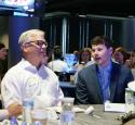 Intern seated and conversating with Valero's President and CEO, Lane Riggs.