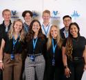 Intern group posed at a Valero branded photobooth.