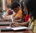 Summit student in session writing notes