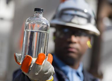 Valero Employee Inspecting oil