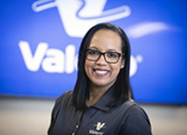 Proud employee in front of Valero marquee