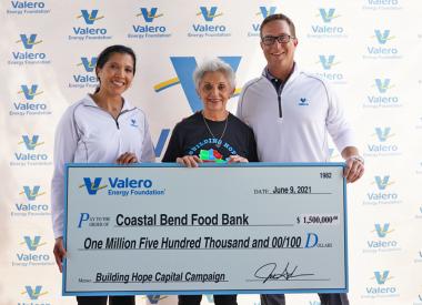 Individuals present a $1.5 million check to the Coastal Bend Food Bank