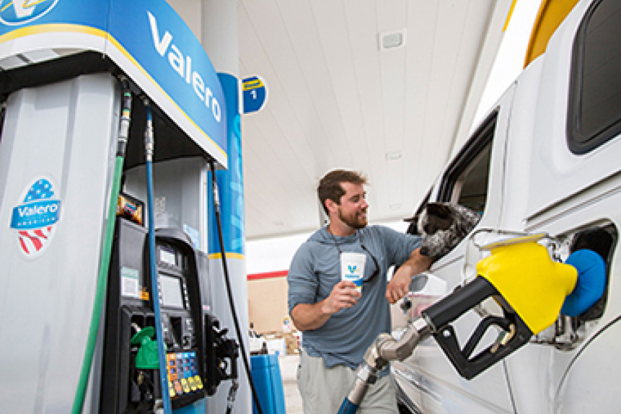 Customer with dog at Valero gas pump