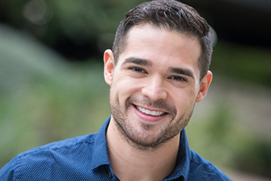 Headshot of man outdoors smiling at camera