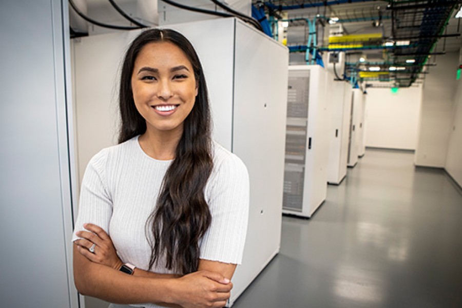 A Valero employee stands with computer equipment.