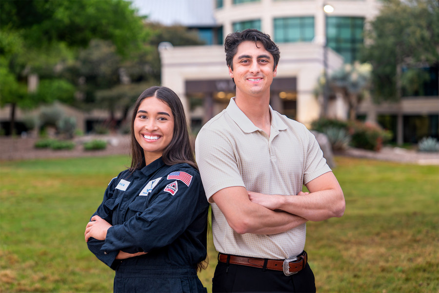 Female and Male Valero Engineers standing in front of Headquarters